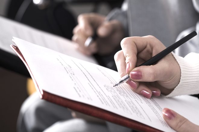 A patient filling out a registration form